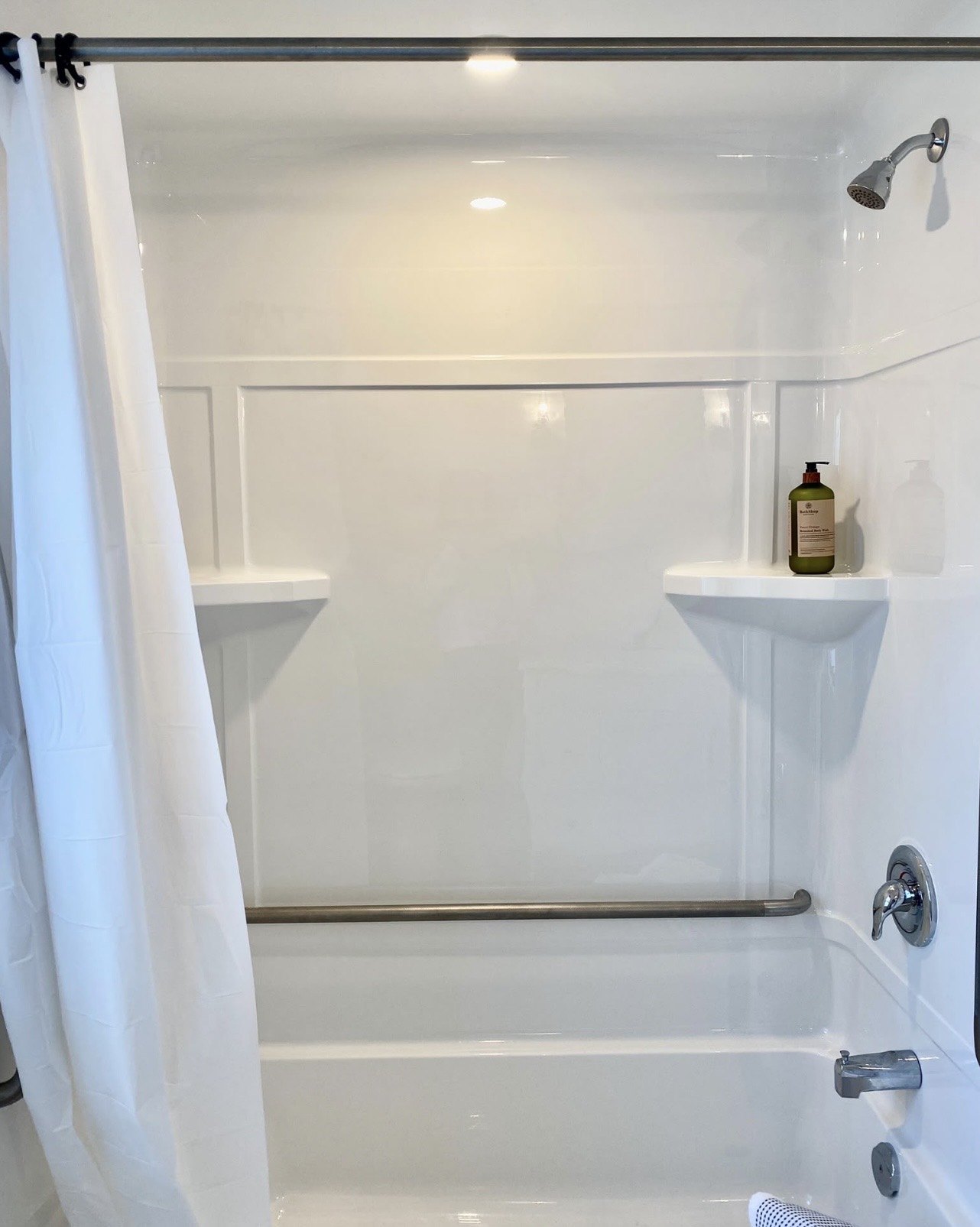 Bath and shower with white surround